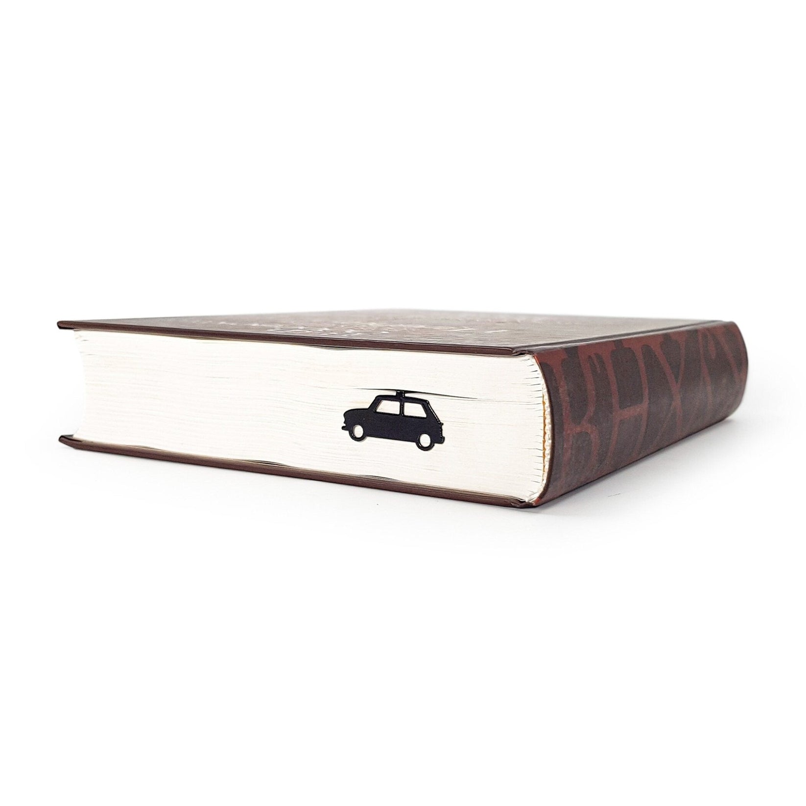 Black Car metal bookmark seen from the edge of a closed book