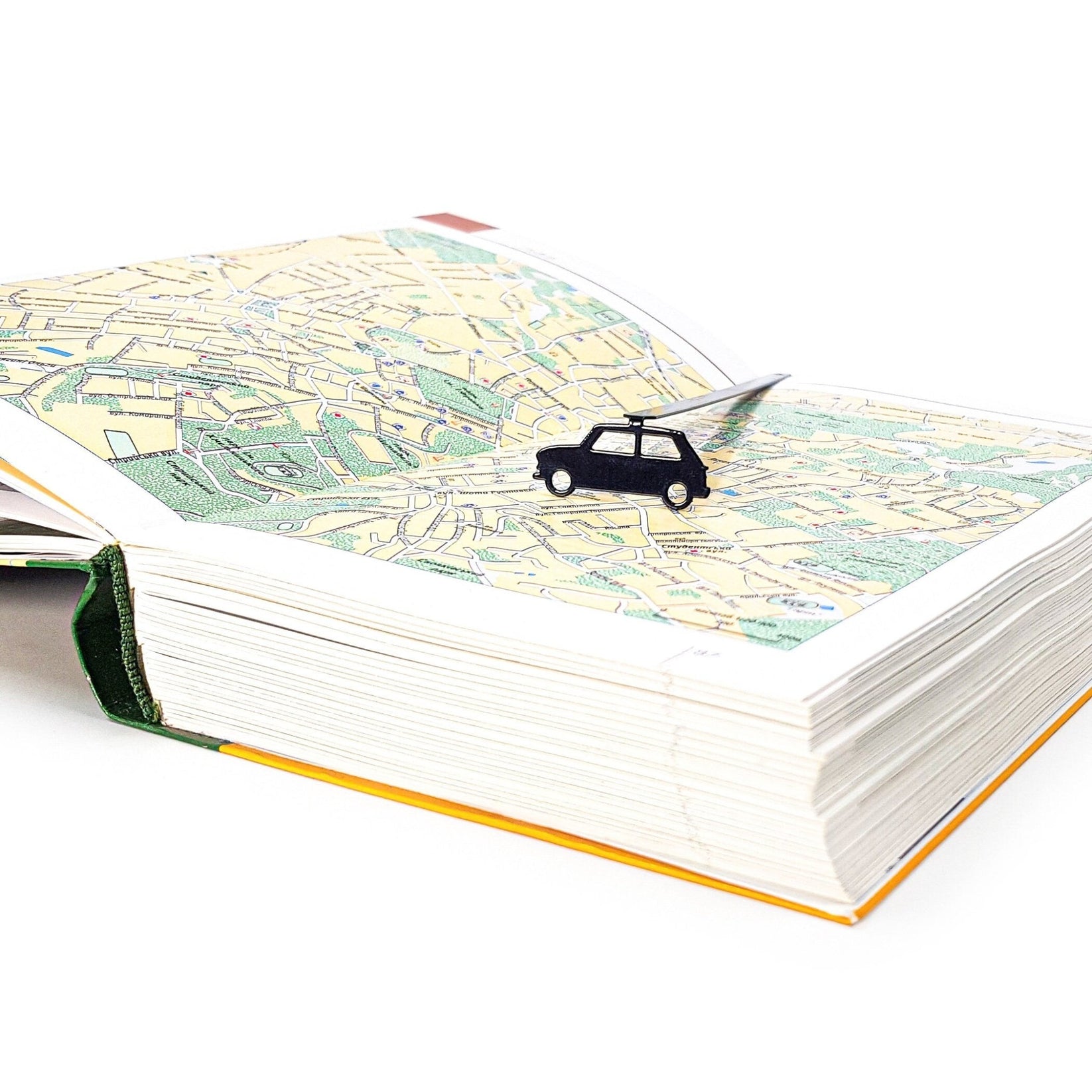 Black Car metal bookmark against a coloured backdrop