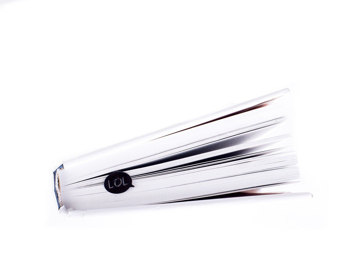 Speech Bubble LOL metal bookmark in a closed book, only its top showing above the pages
