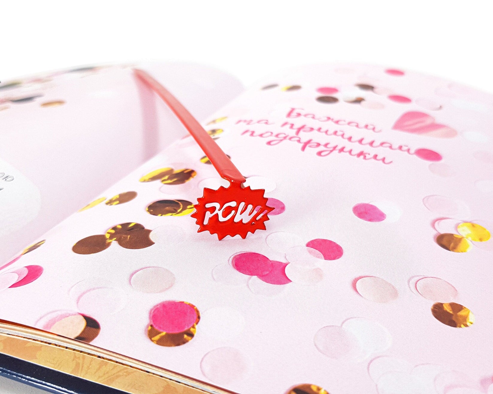 Speech Bubble Pow metal bookmark in red against a coloured backdrop