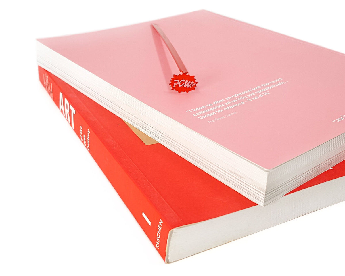 Speech Bubble Pow metal bookmark in red seen from the edge of a closed book