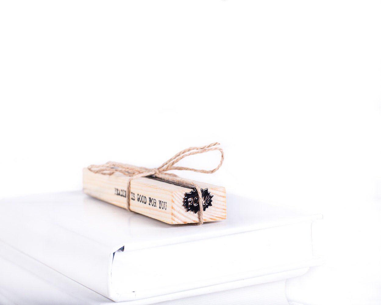 Speech Bubble Pow metal bookmark in red with the engraved wooden gift block it ships with