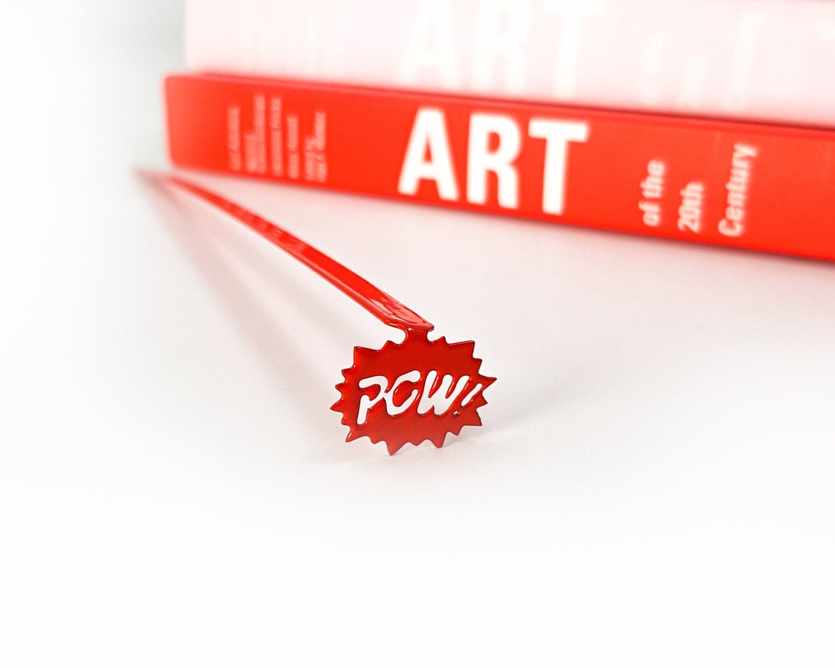 Speech Bubble Pow metal bookmark in red on a coloured background