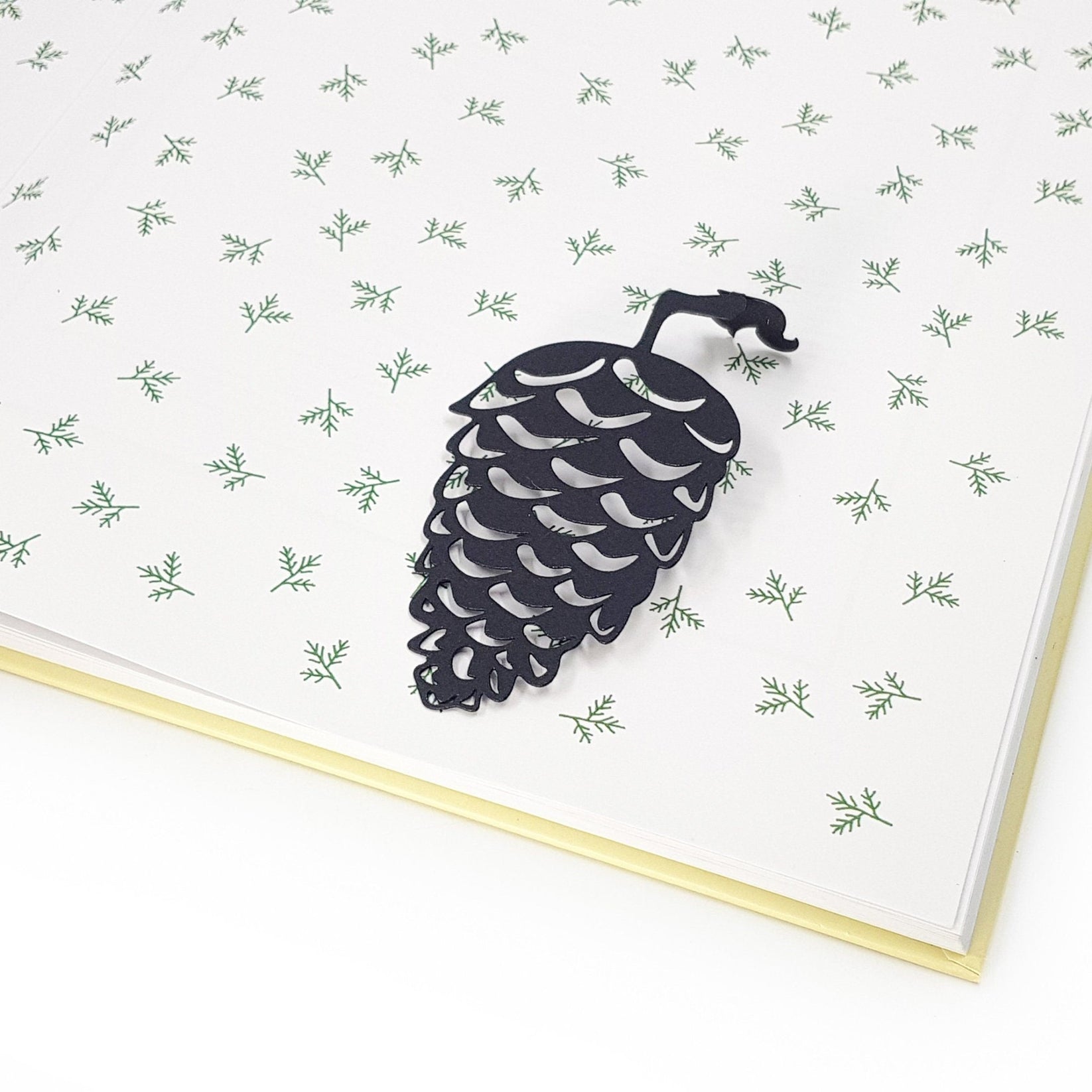 Squirrel and a Pinecone metal bookmark on a coloured background