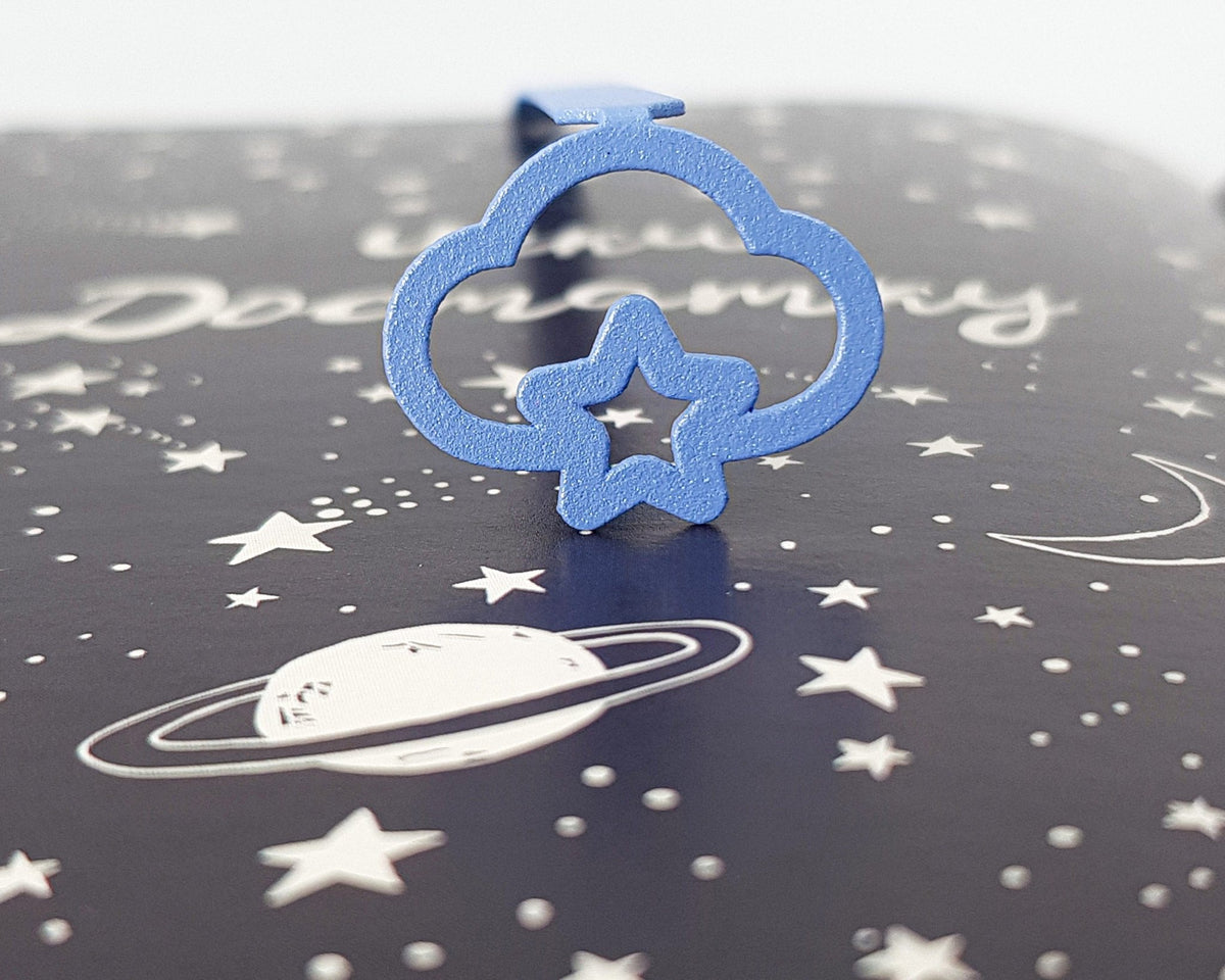 Star Cloud metal bookmark in blue on a coloured background