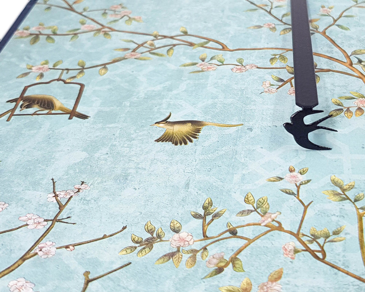 Swallow metal bookmark against a coloured backdrop