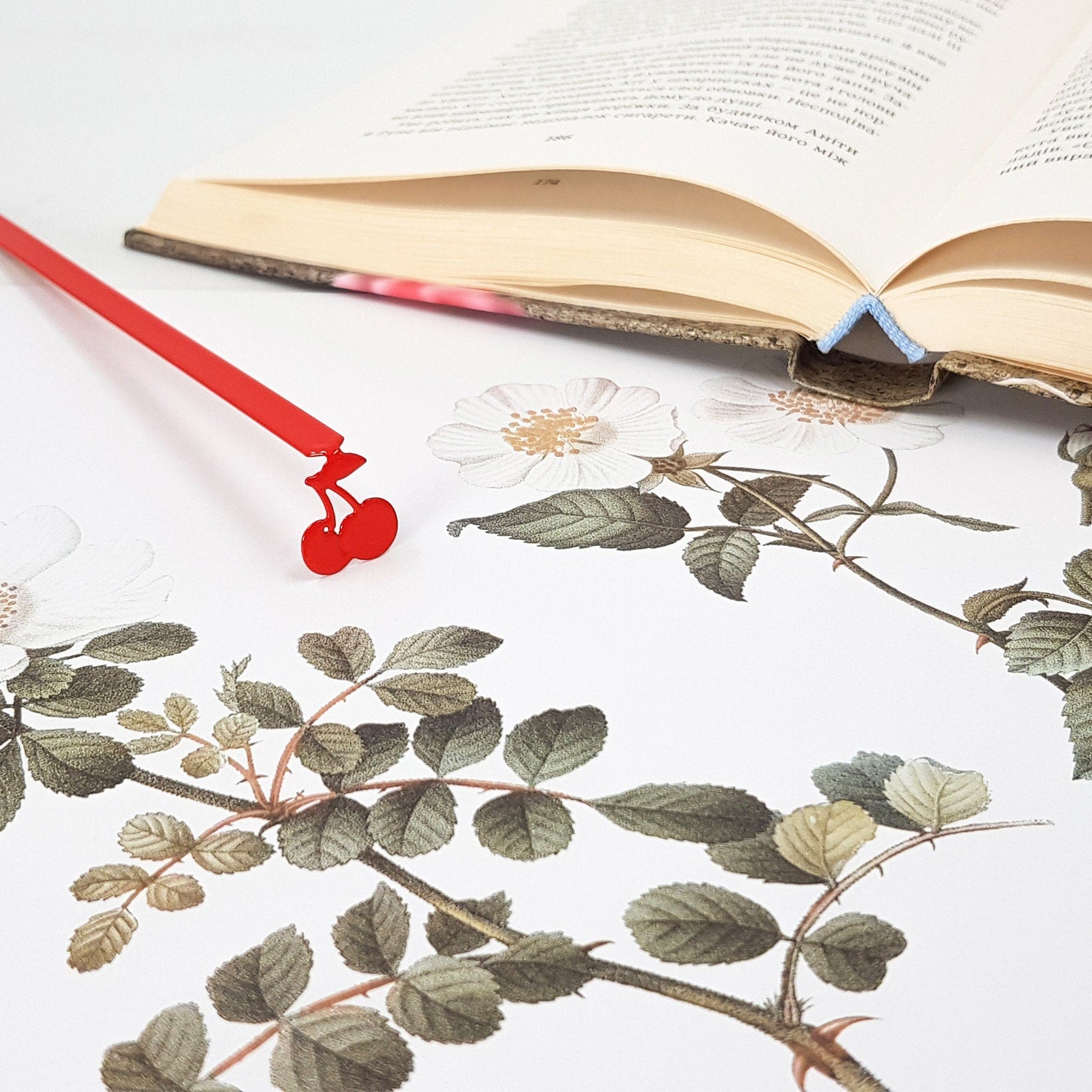 Sweet Cherries metal bookmark in red against a coloured backdrop