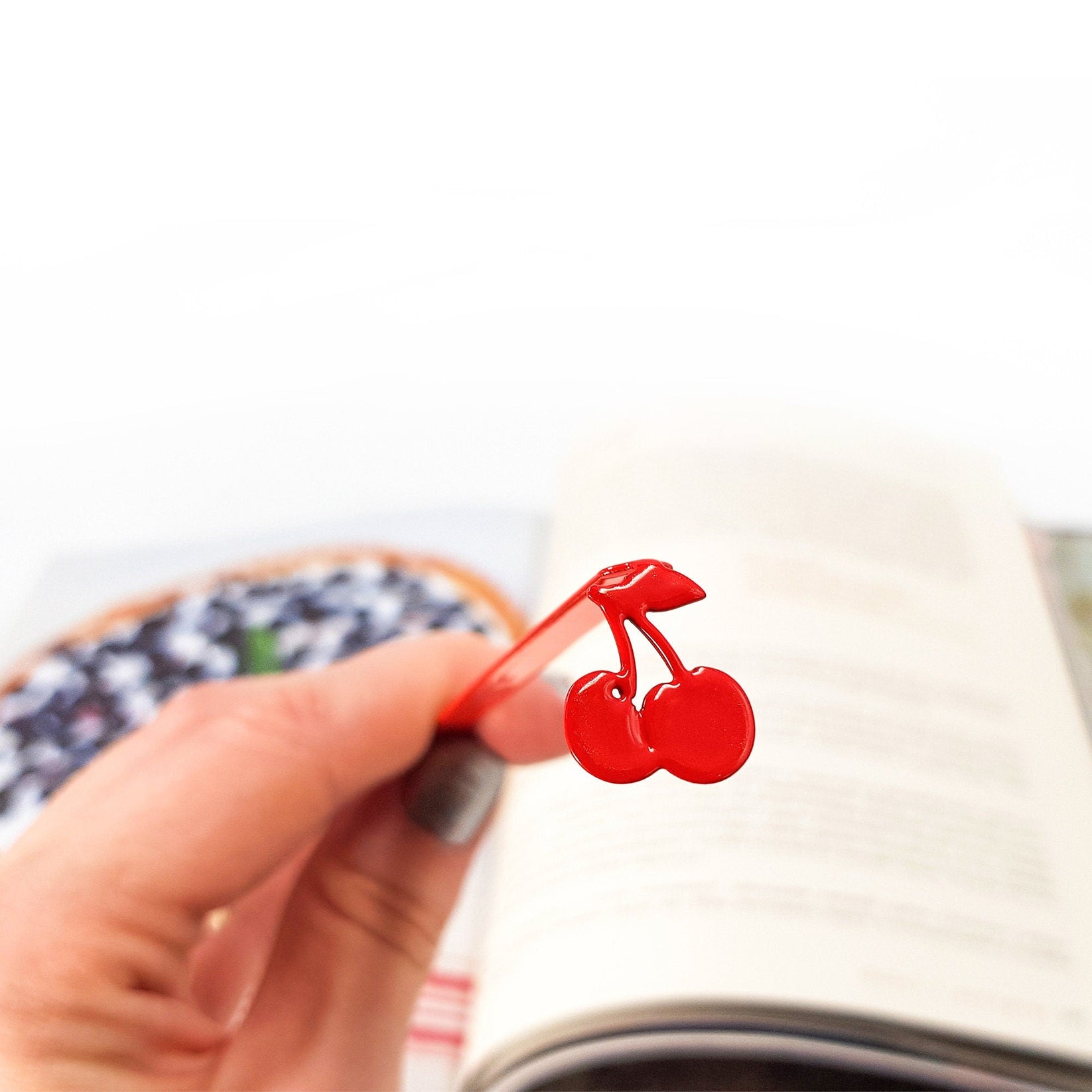 Sweet Cherries metal bookmark in red on a coloured background, view 4