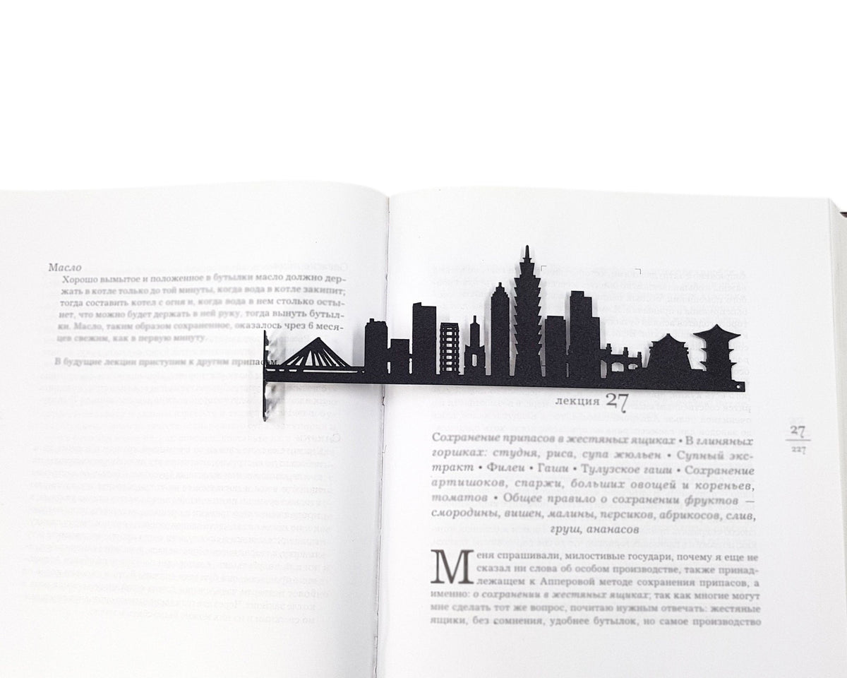Taipei metal bookmark resting on the pages of an open book