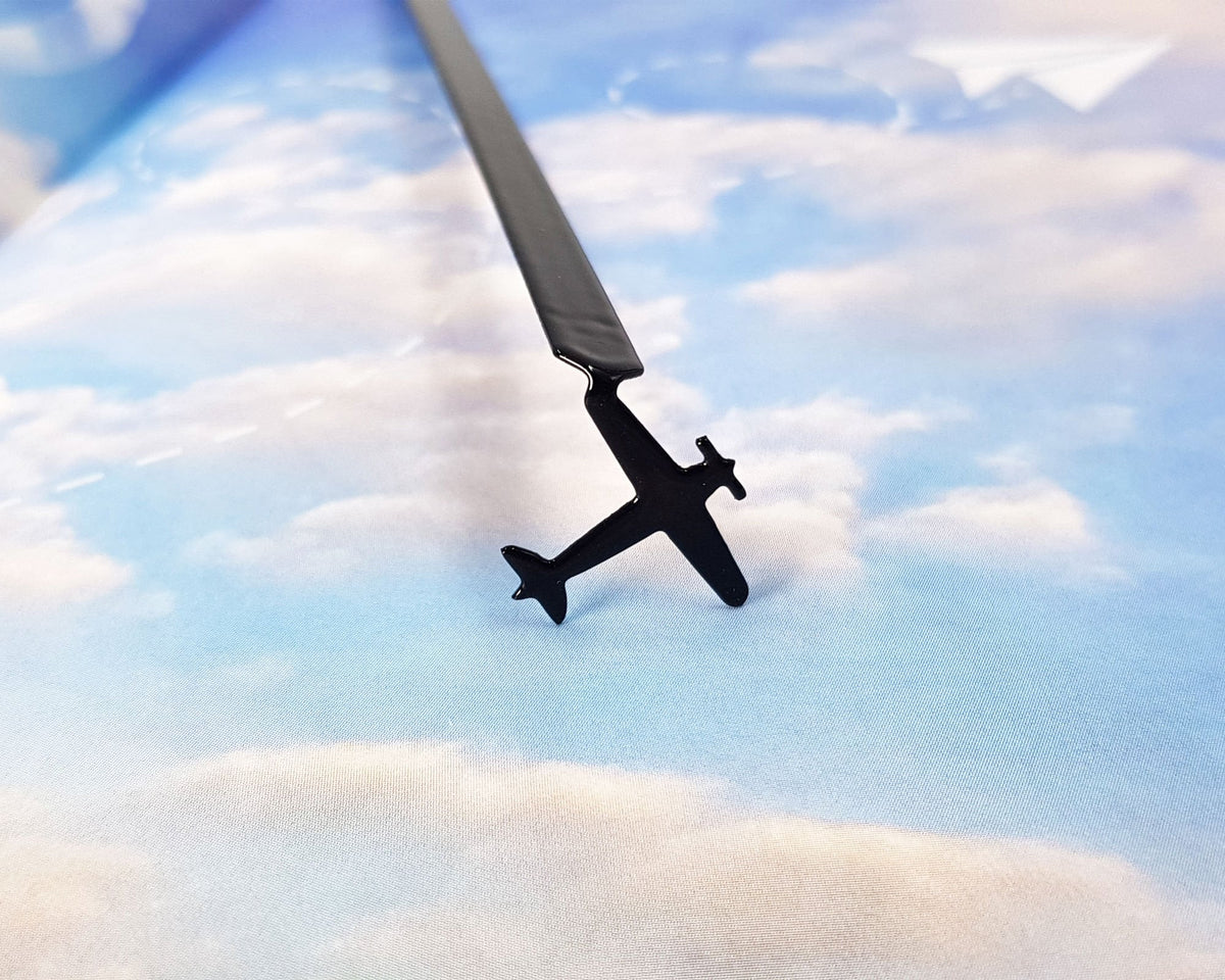 Take a Book Will Fly metal bookmark on a coloured background