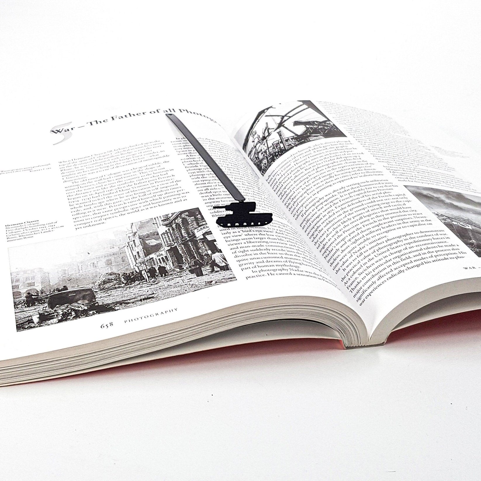 Tank metal bookmark marking a page in an illustrated book