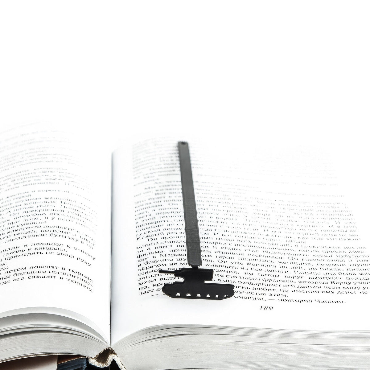 Tank metal bookmark marking a page in an open book