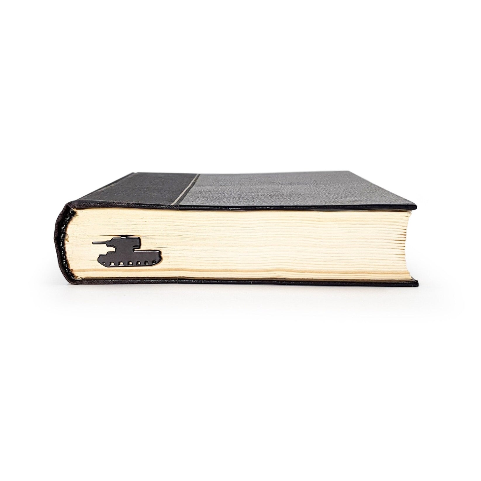 Tank metal bookmark seen from the edge of a closed book