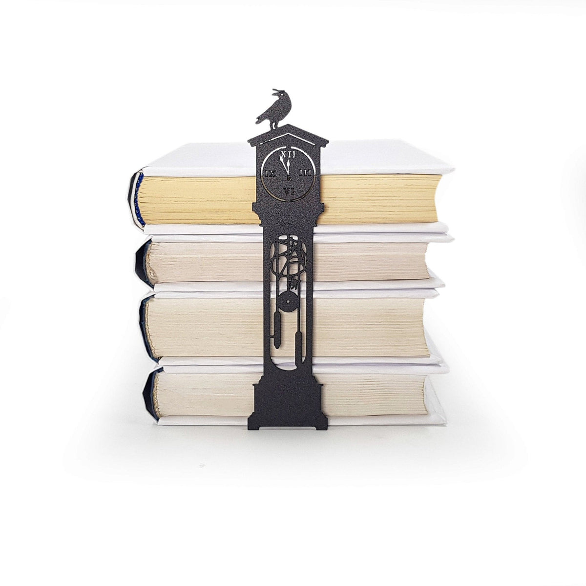 The Raven's Pendulum Dance metal bookmark shown with a stack of books