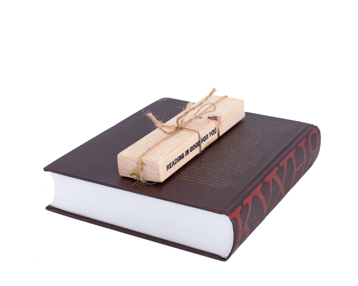 The Sacred Ibis metal bookmark in gold shown with its wooden gift block