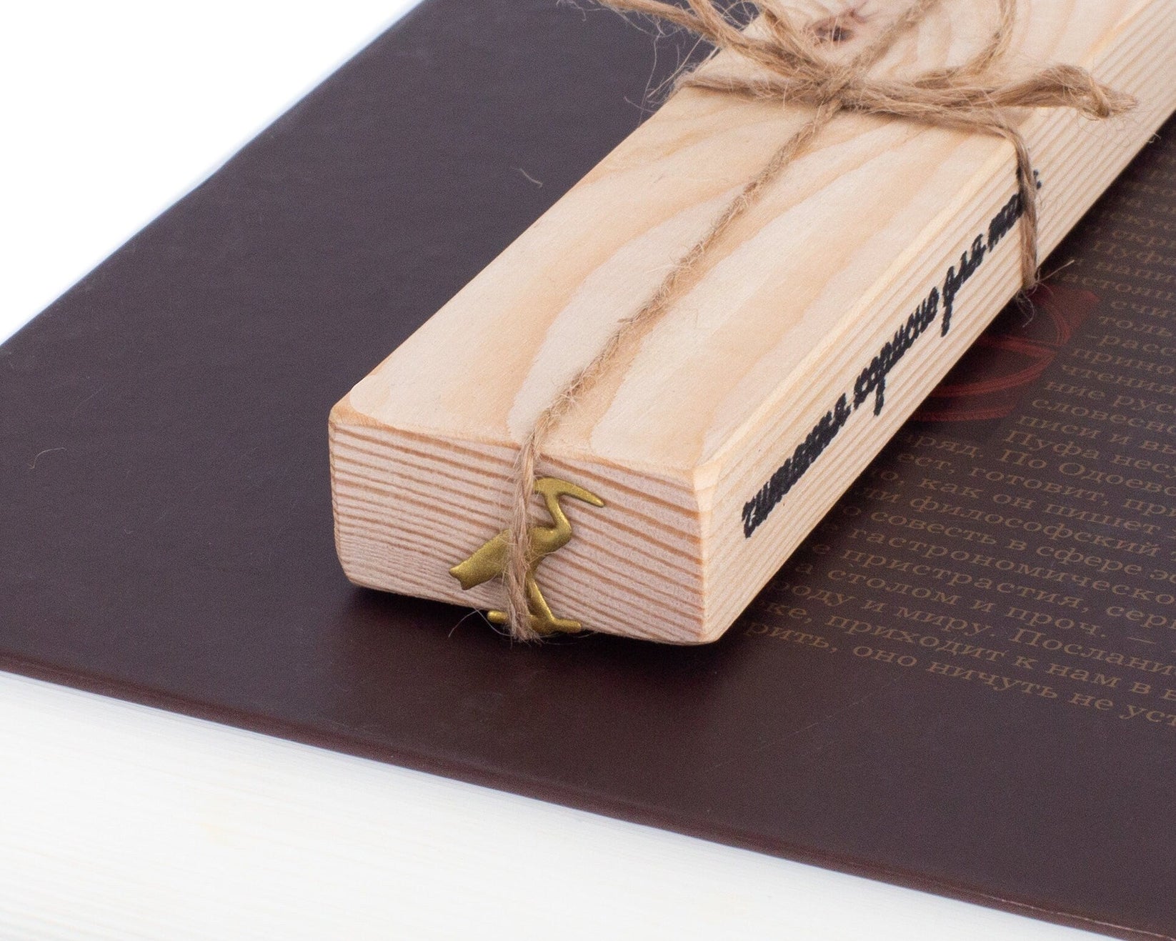 The Sacred Ibis metal bookmark in gold packed with kraft paper and twine as a gift
