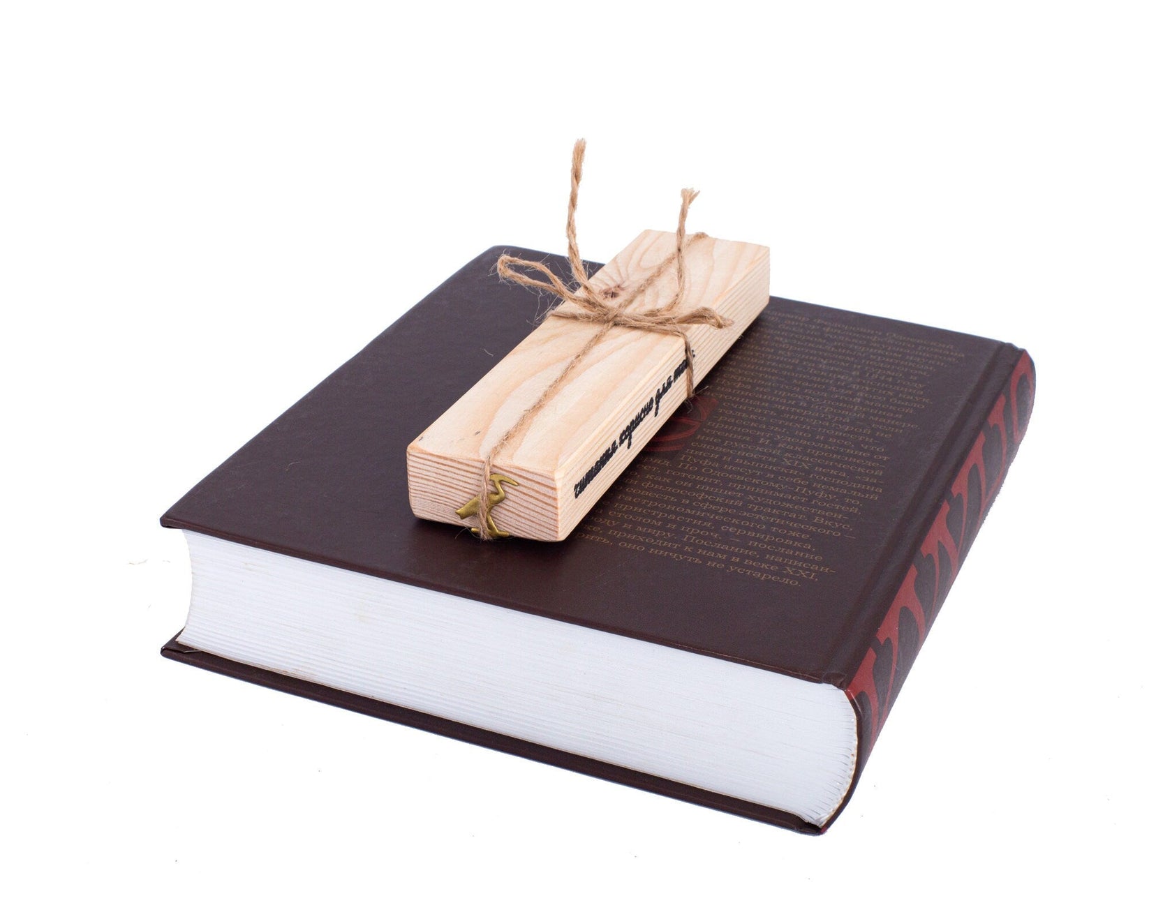 The Sacred Ibis metal bookmark in gold with the engraved wooden gift block it ships with