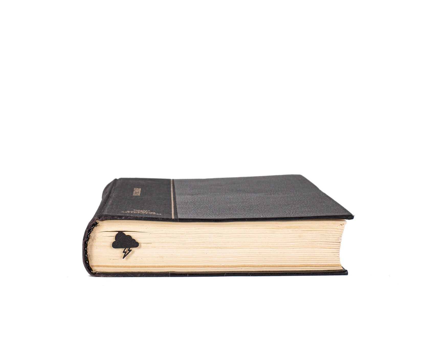 Thunderstorm metal bookmark in a closed book, only its top showing above the pages