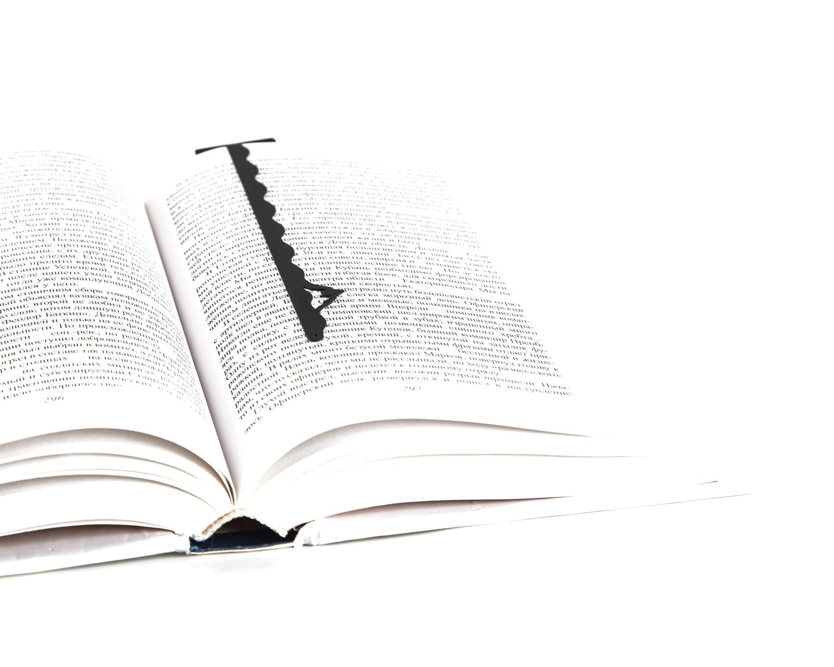 Titanic metal bookmark resting on the pages of an open book