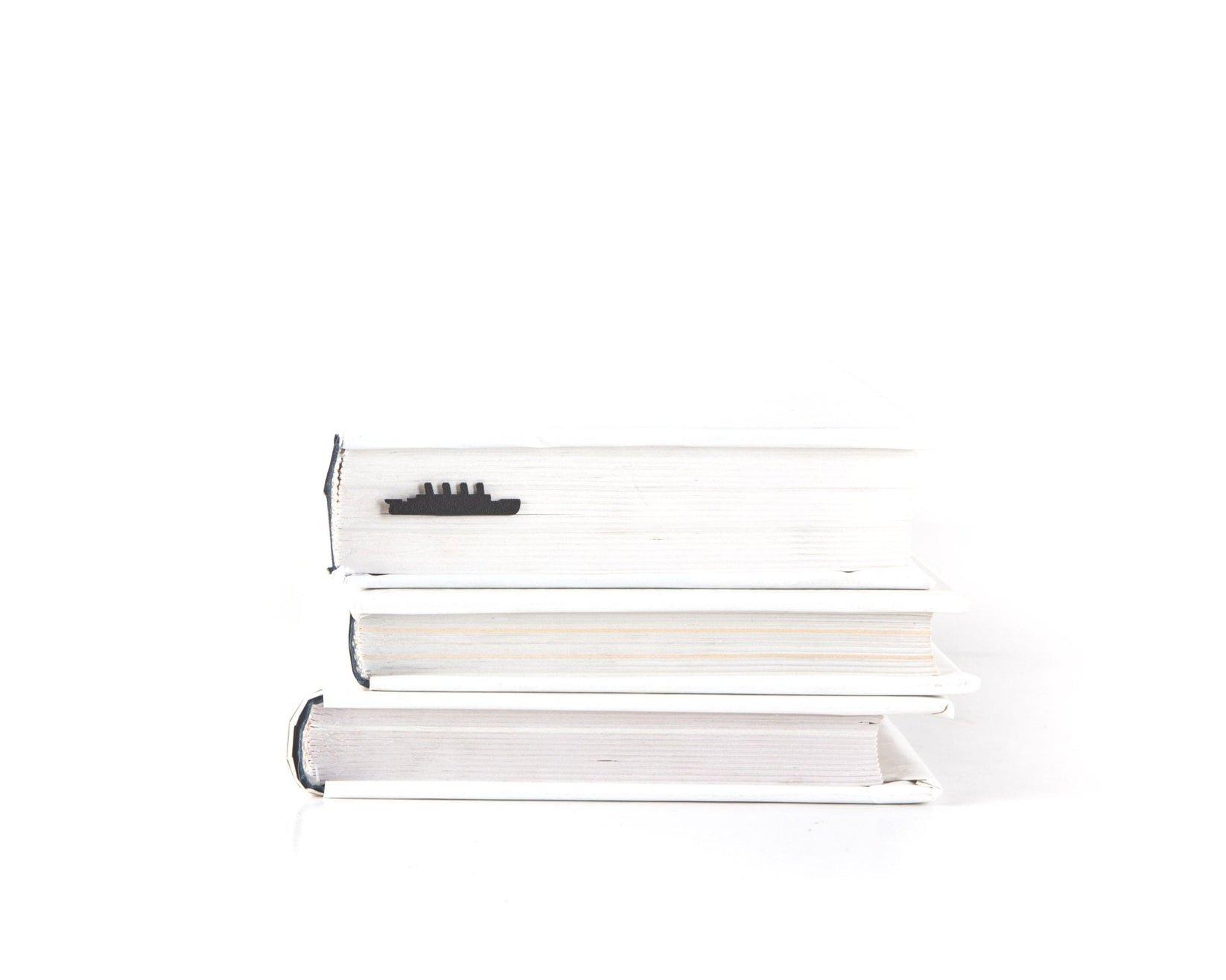 Titanic metal bookmark seen from the edge of a closed book