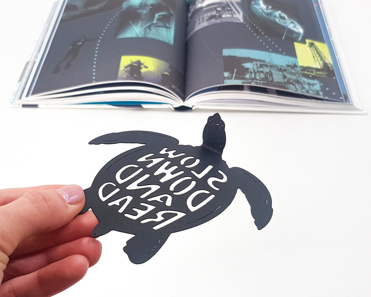 Turtle metal bookmark on an illustrated page, view 5