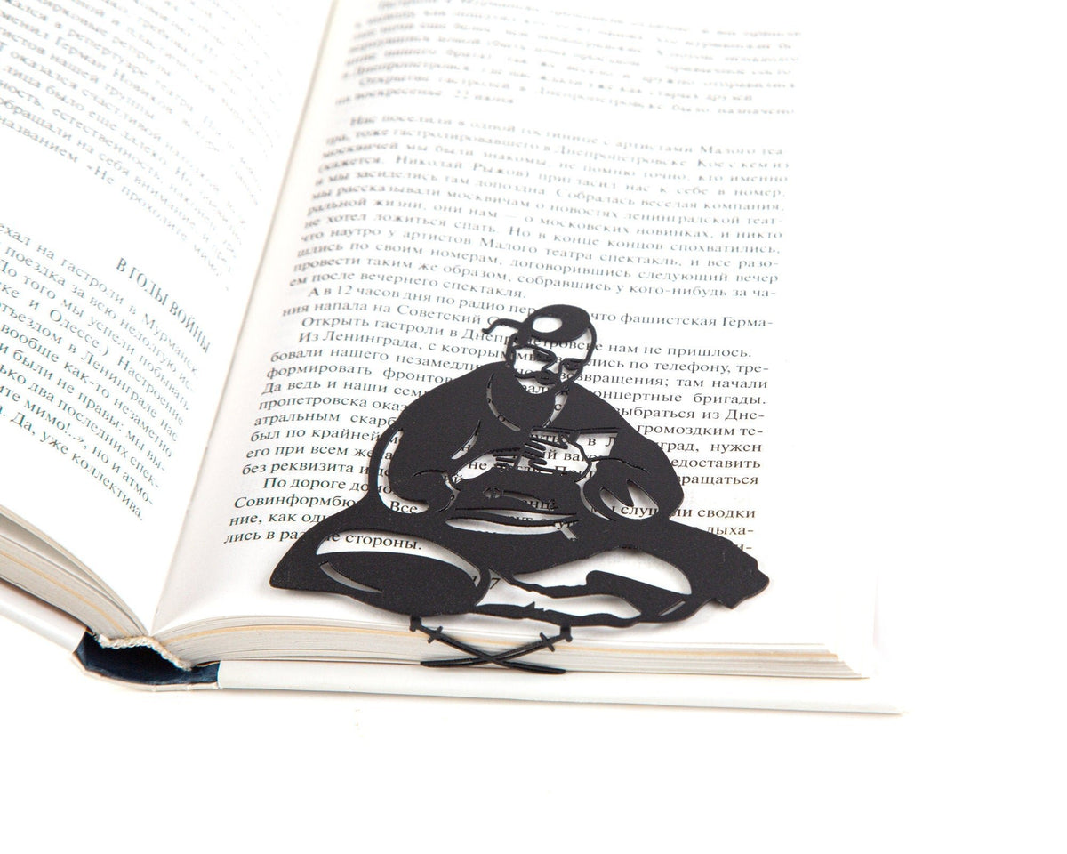 Ukrainian Kozak metal bookmark resting on the pages of an open book