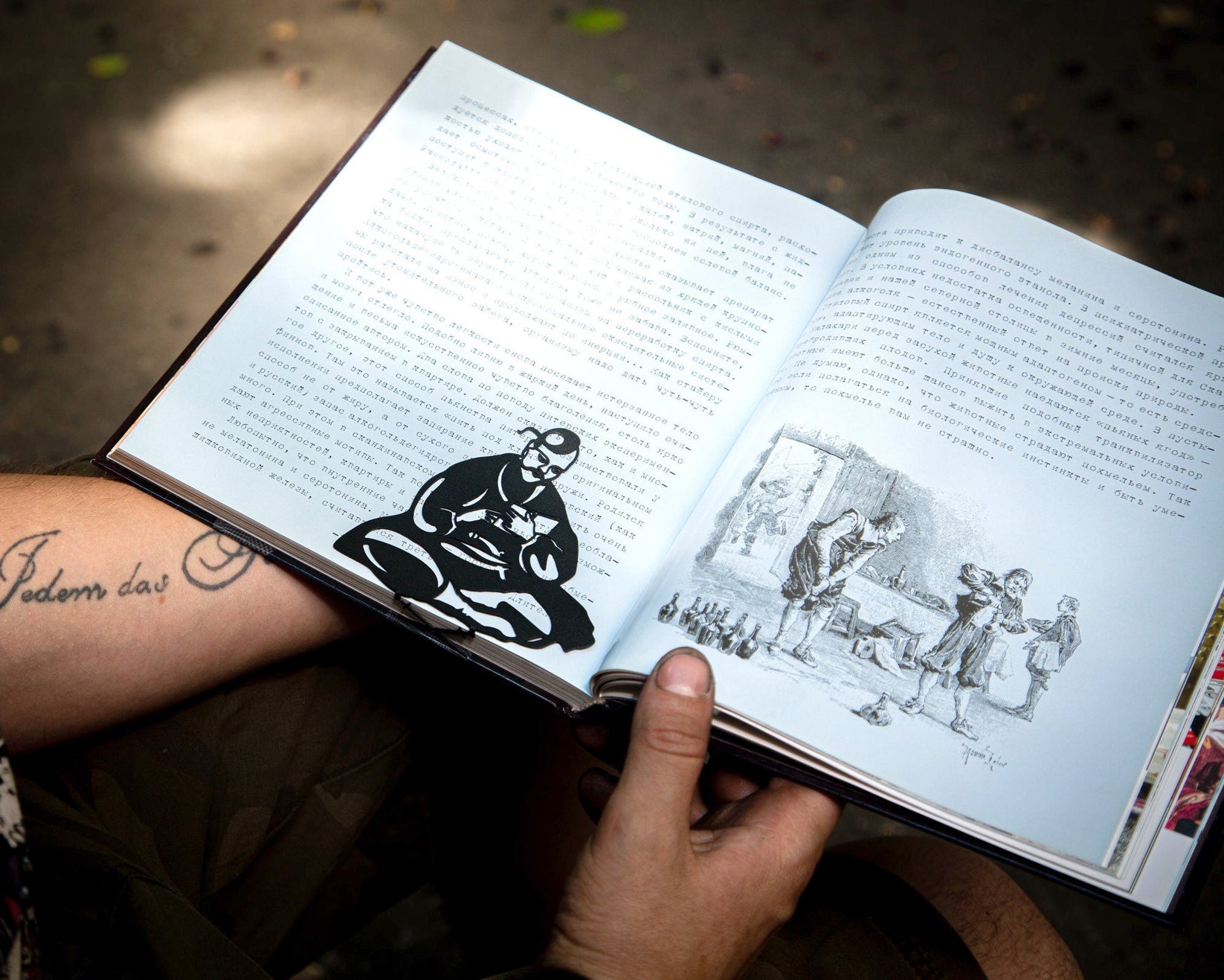 Ukrainian Kozak metal bookmark held in a hand above an open book
