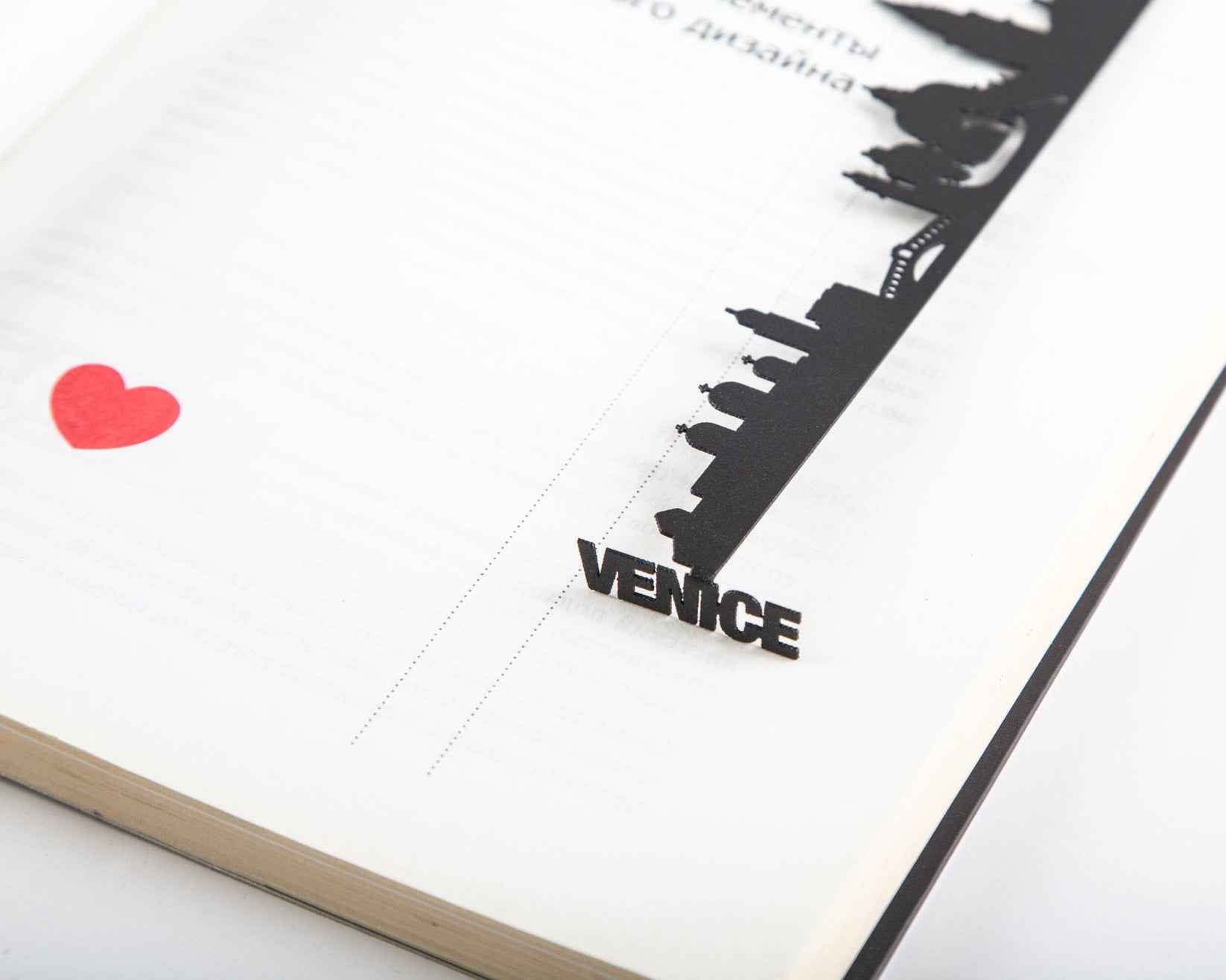 Venice metal bookmark marking a page in a notebook