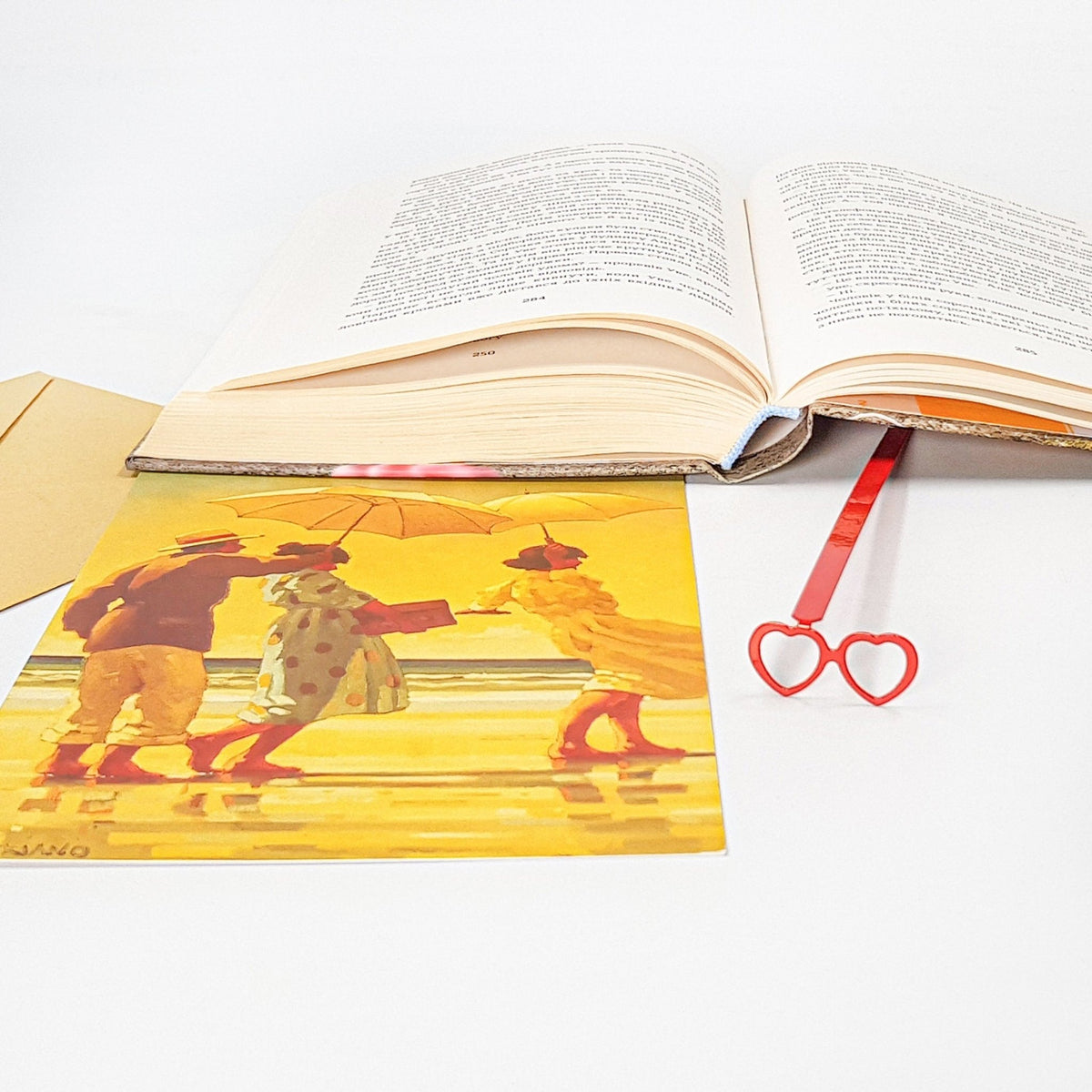 Vision Love metal bookmark in red placed on a colour illustration