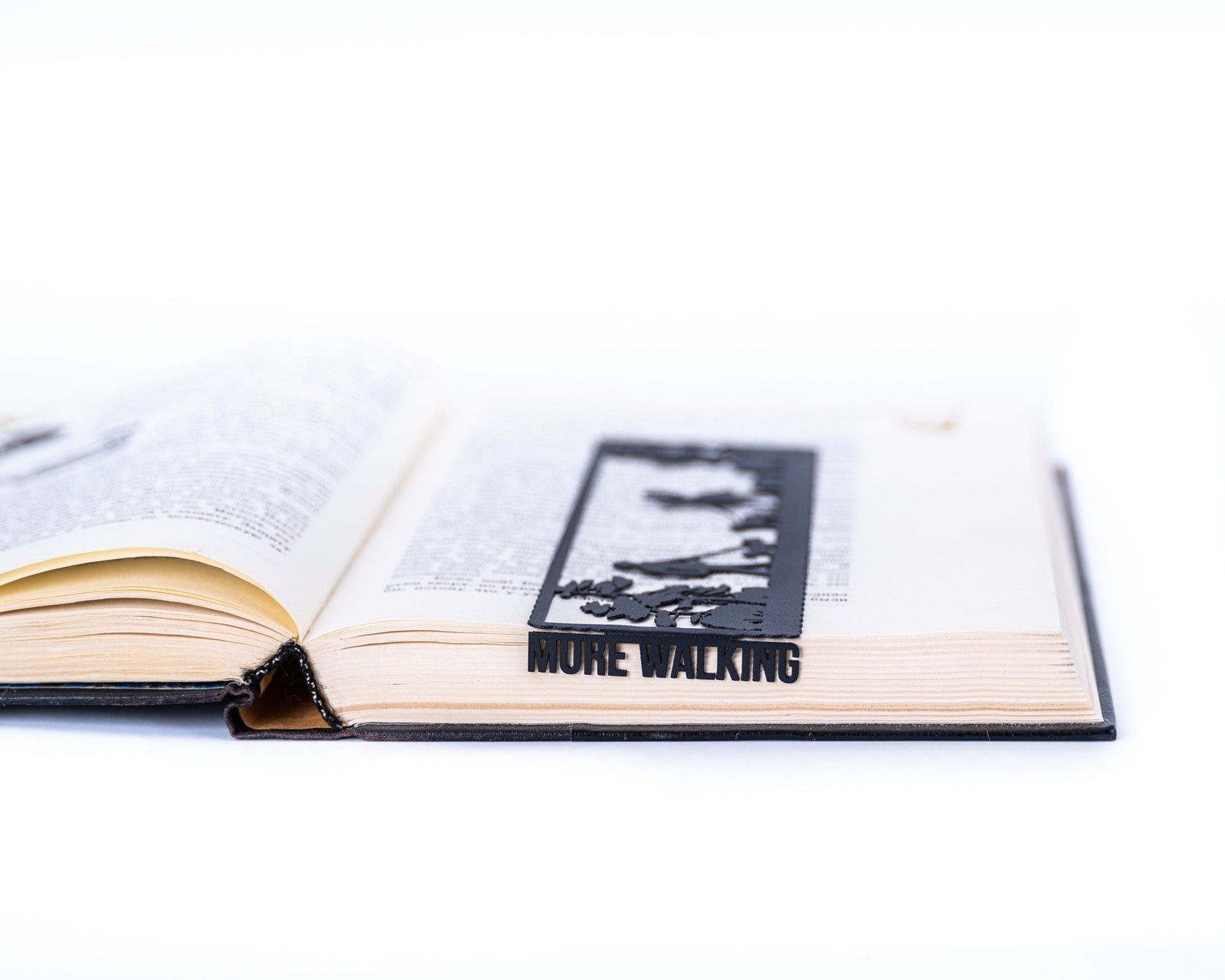 Dog Lover metal bookmark resting on the pages of an open book