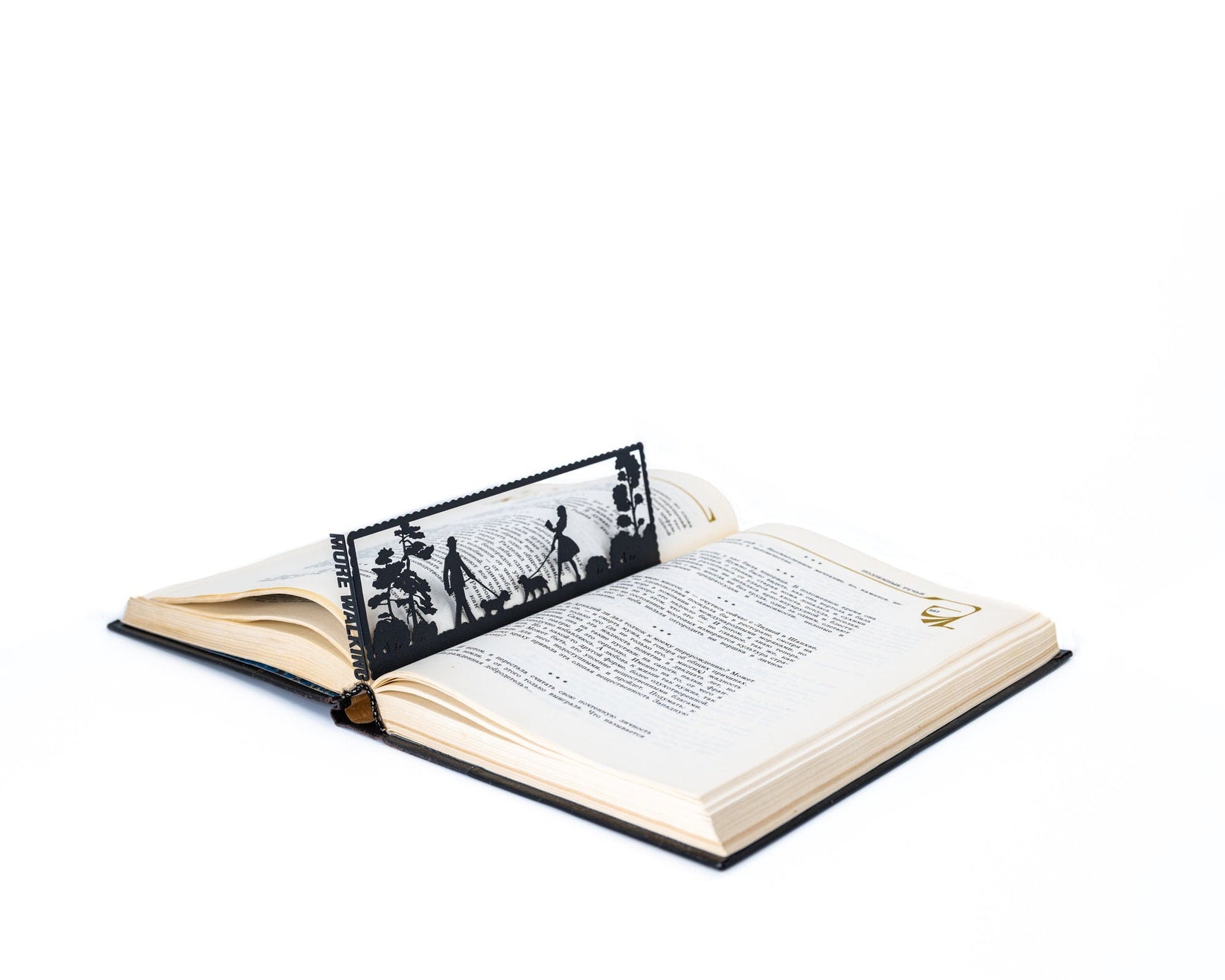 Dog Lover metal bookmark marking a page in an open book