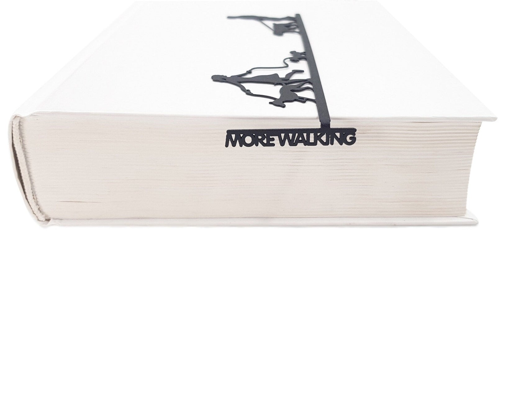 Walking the Dog metal bookmark in a closed book, only its top showing above the pages