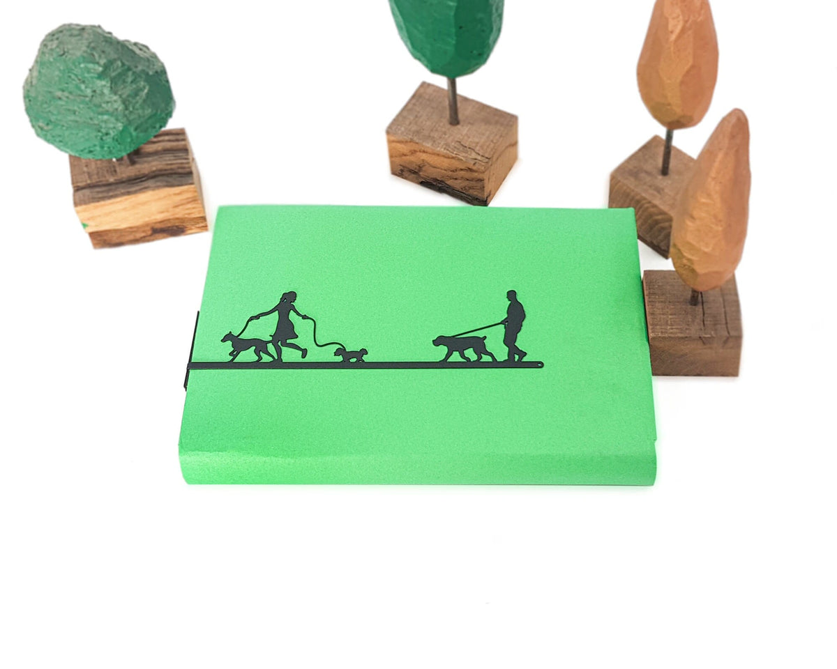 Walking the Dog metal bookmark on a coloured background