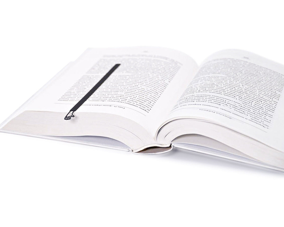 Waving Hand metal bookmark resting on the pages of an open book