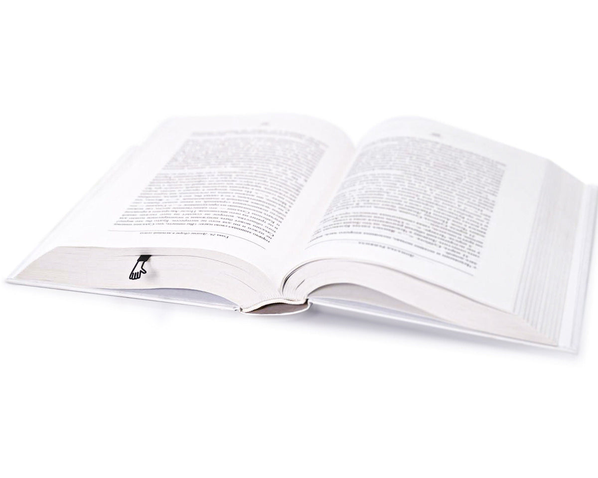 Waving Hand metal bookmark marking a page in an open book