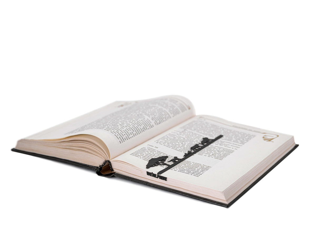 We're a Pride metal bookmark lying across the pages of an open book