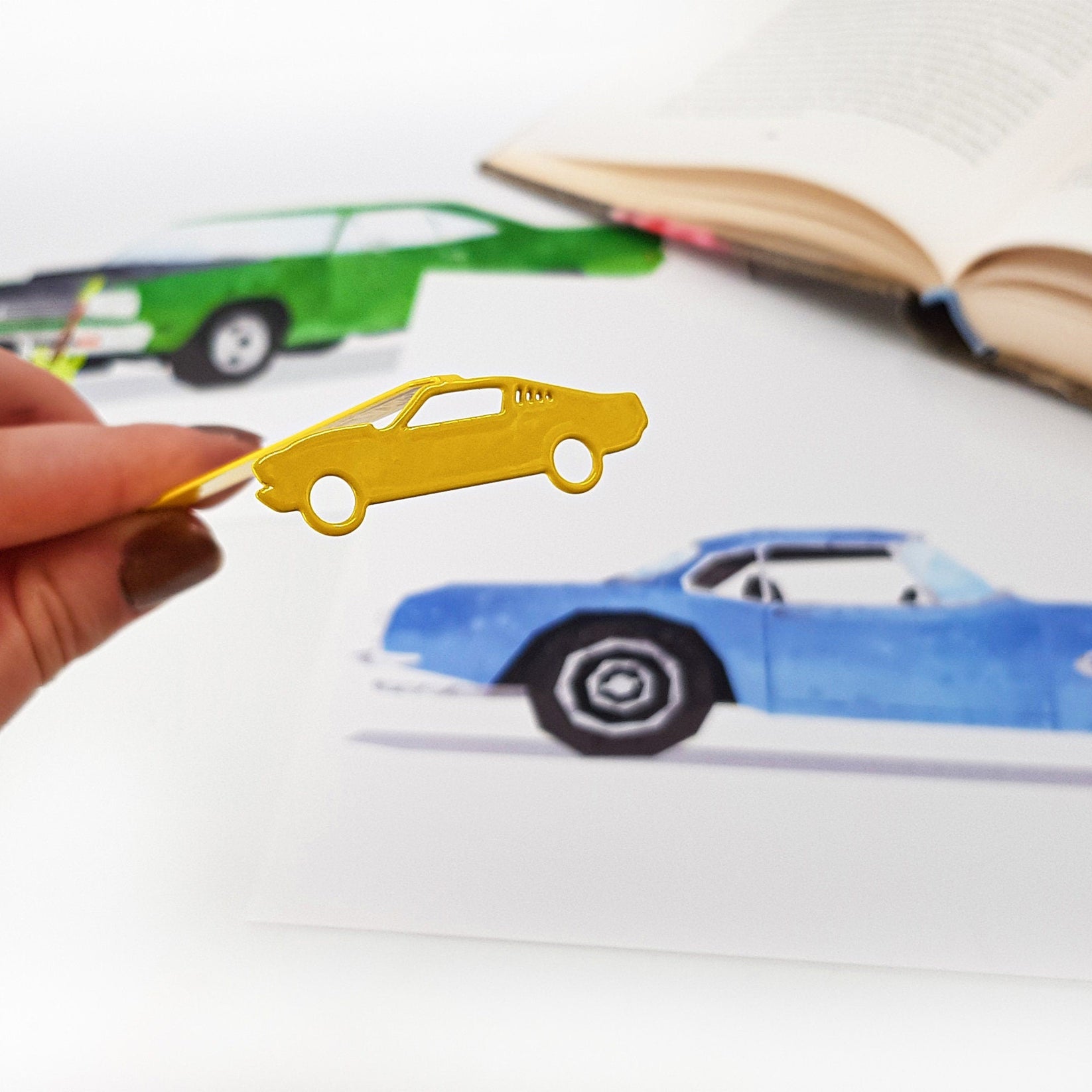 Yellow Muscle Car metal bookmark in gold on an illustrated page