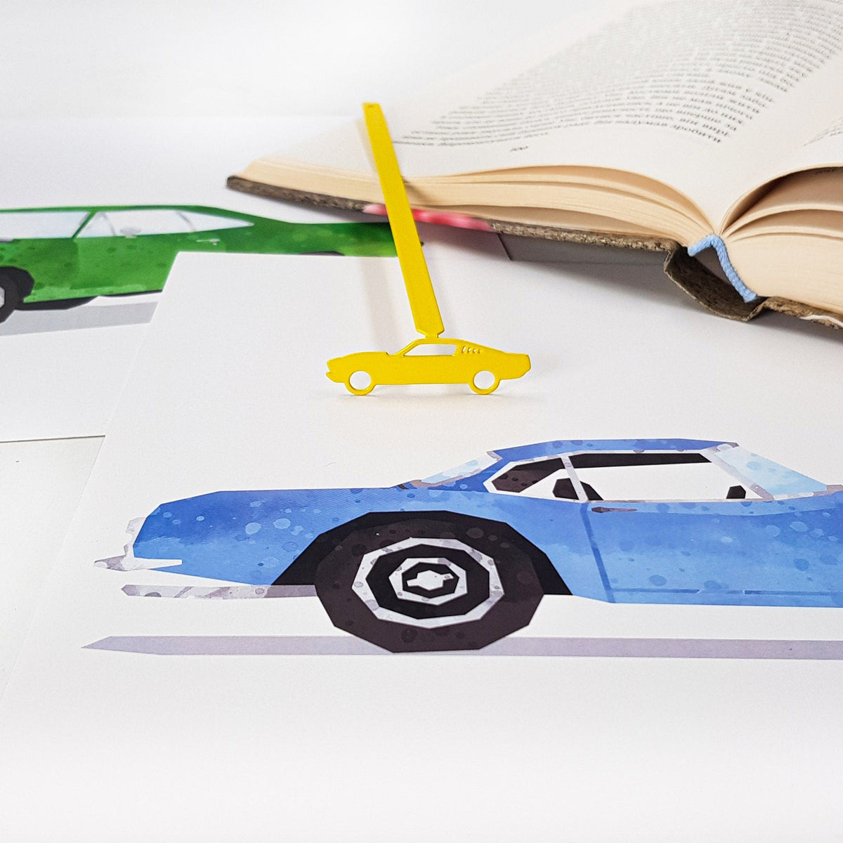 Yellow Muscle Car metal bookmark in gold marking a page in an illustrated book