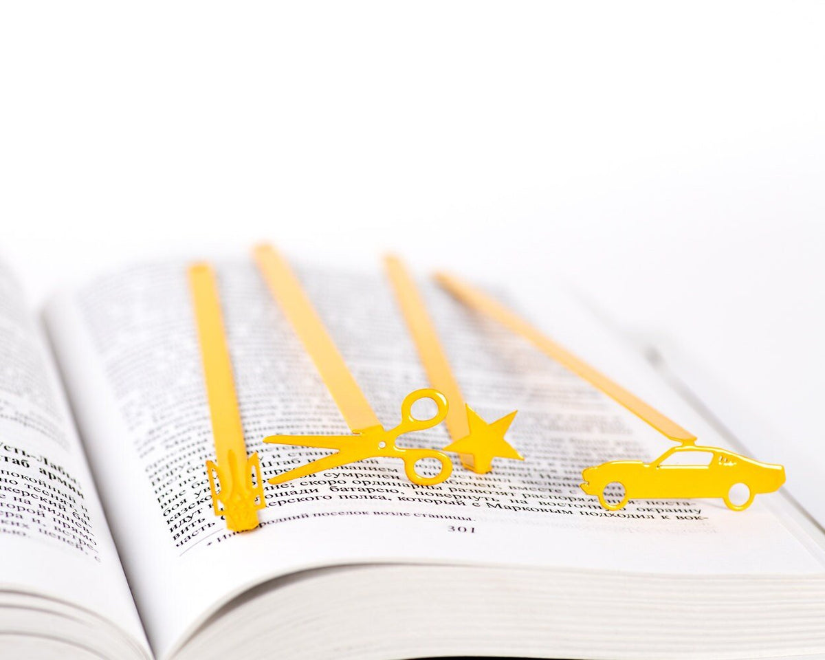 Yellow Star metal bookmark in gold shown together with other bookmarks from the range
