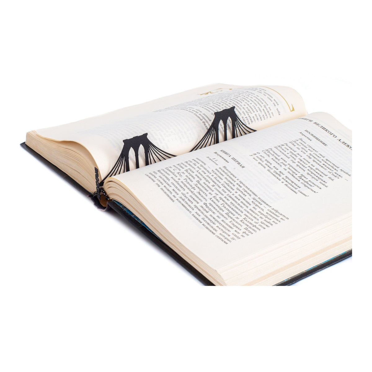 Brooklyn Bridge metal bookmark resting on the pages of an open book