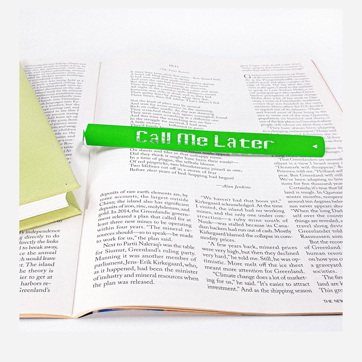 Call Me Later metal bookmark in green resting on the pages of an open book