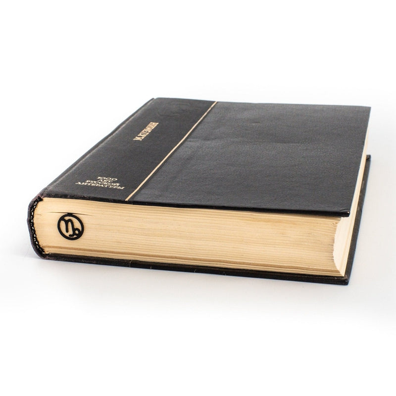 Capricorn metal bookmark in a closed book, only its top showing above the pages