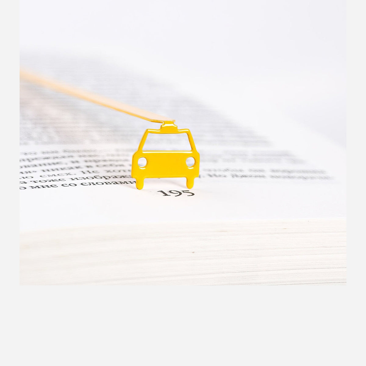 Car metal bookmark in gold shown flat on a white background