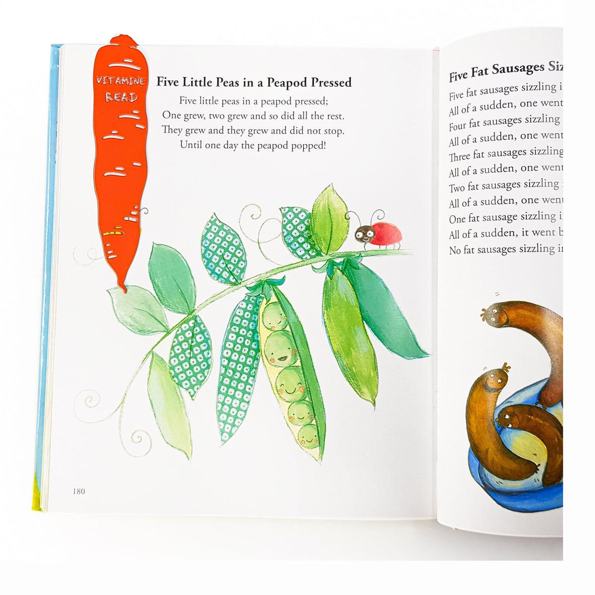 Carrot metal bookmark in red marking a page in an illustrated book