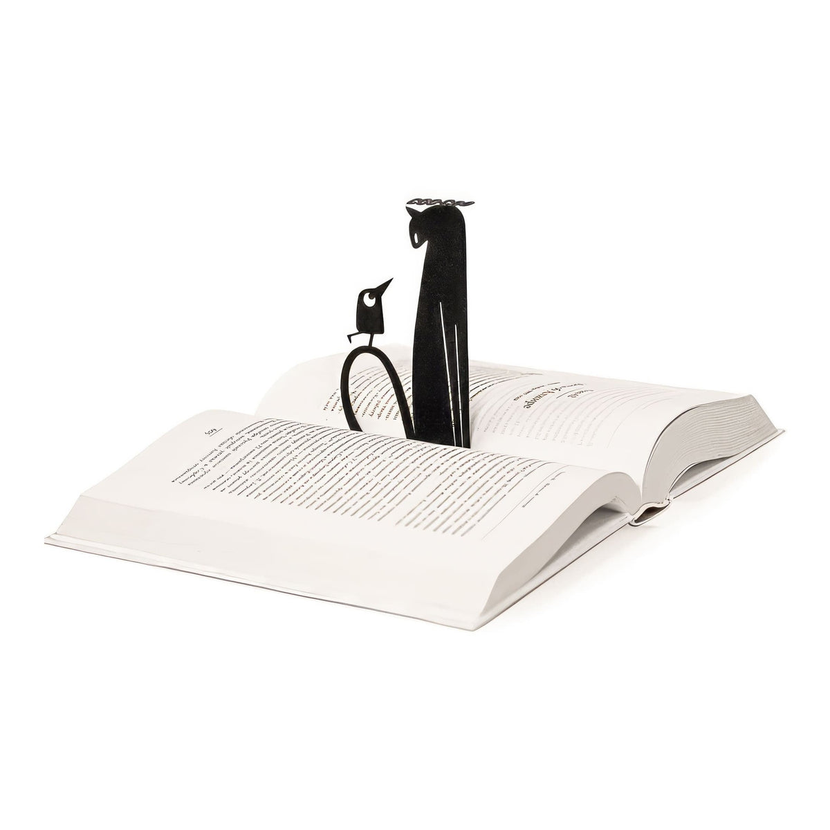 Cat and Bird Coo Coo metal bookmark resting on the pages of an open book