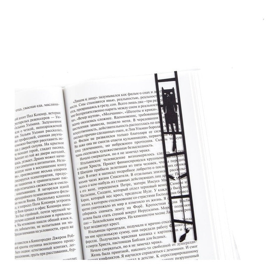 Cat and the Fish metal bookmark resting on the pages of an open book