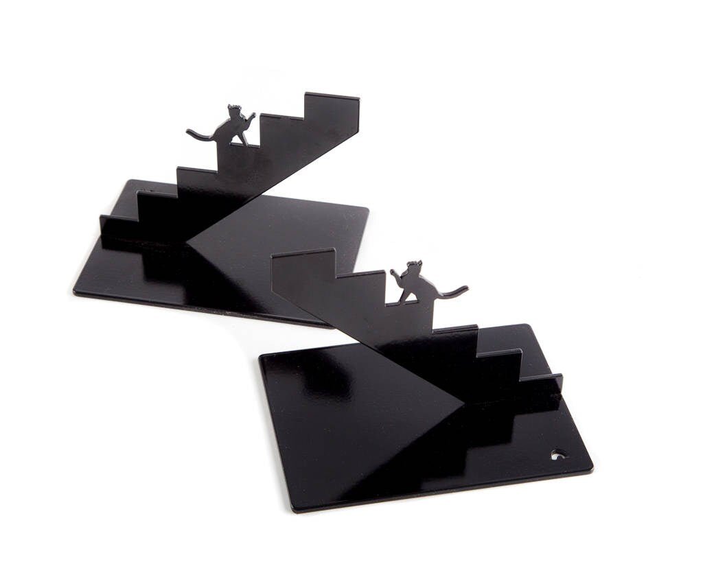 Pair of black staircase-shaped cat metal bookends on white