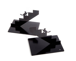 Pair of black staircase-shaped cat metal bookends on white