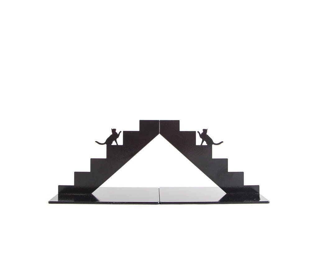 Black staircase-shaped cat metal bookends forming a peak