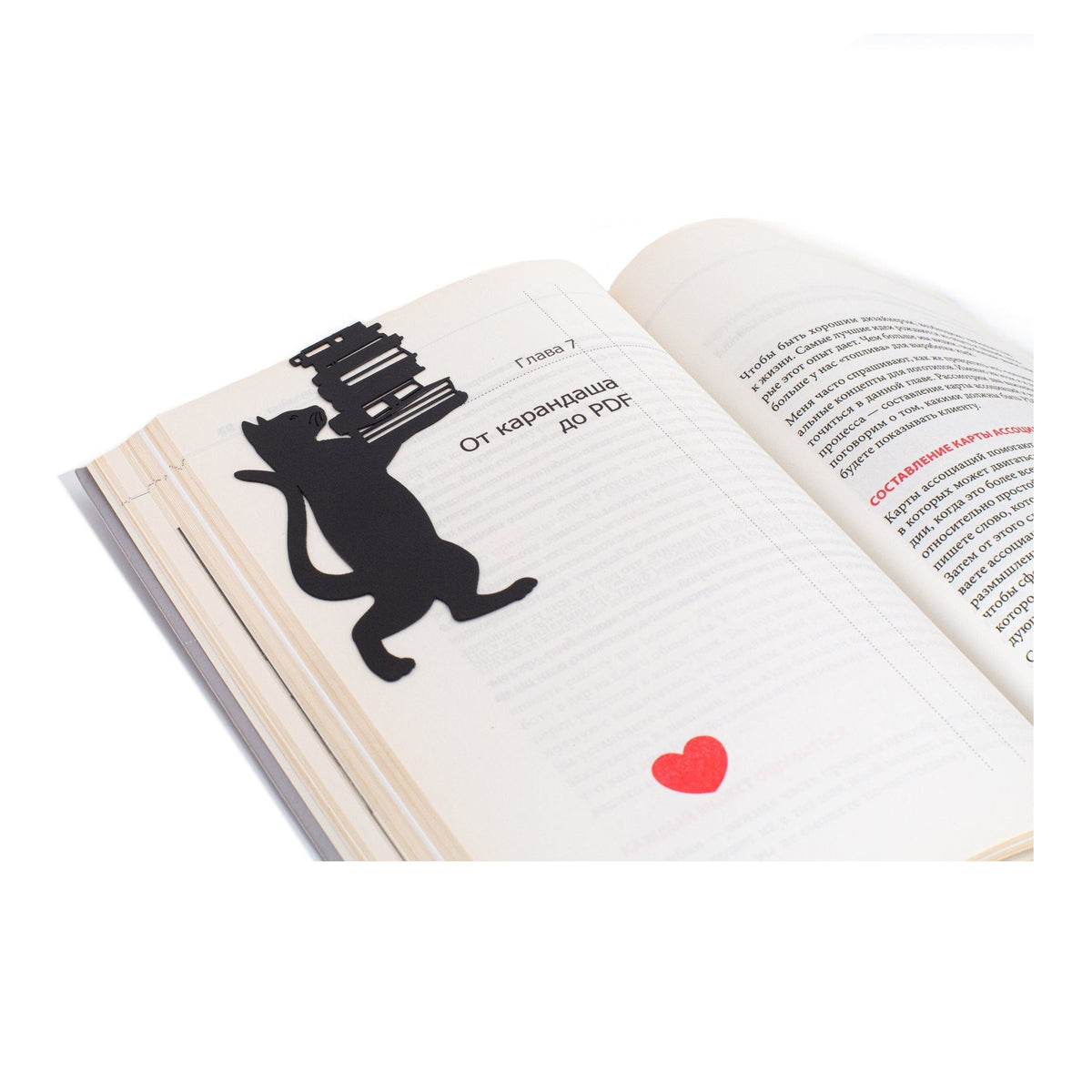 Cat the Librarian metal bookmark resting on the pages of an open book